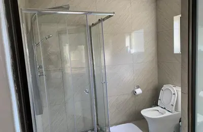 a bathroom with a shower and a toilet at Yami Nawe Lodge in Dennilton