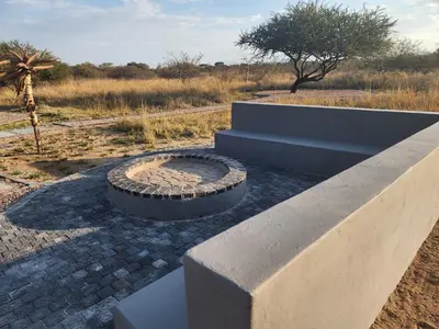 a fire pit in the middle of a field at Musanda Villa 413 Euphoria in Naboomspruit