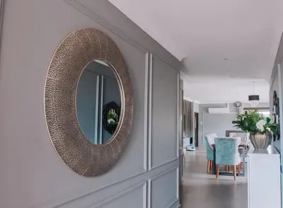 a mirror on a wall in a living room at Musanda Villa 413 Euphoria in Naboomspruit
