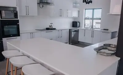 a kitchen with white cabinets and a white counter top at Musanda Villa 413 Euphoria in Naboomspruit
