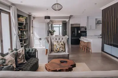 a living room with a couch and a table at Musanda Villa 413 Euphoria in Naboomspruit
