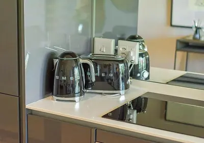 a counter with two tea pots and a coffee maker at 5 Star Elegant Apartments, Ellipse, Waterfall City, Midrand, Johannesburg in Midrand