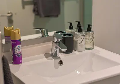 a bathroom sink with toiletries on top of it at 5 Star Elegant Apartments, Ellipse, Waterfall City, Midrand, Johannesburg in Midrand