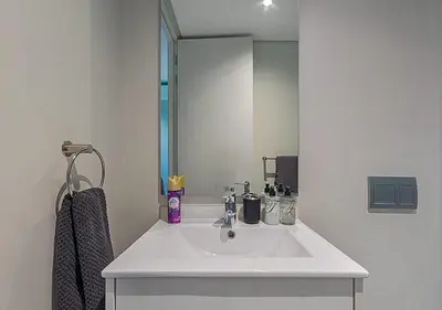 a bathroom with a white sink and a mirror at 5 Star Elegant Apartments, Ellipse, Waterfall City, Midrand, Johannesburg in Midrand