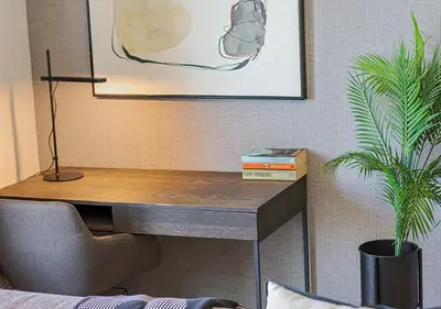 a desk in a room with a potted plant at 5 Star Elegant Apartments, Ellipse, Waterfall City, Midrand, Johannesburg in Midrand