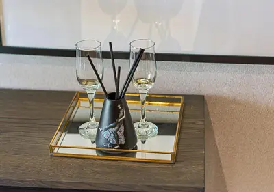 a black vase with two wine glasses on a tray at 5 Star Elegant Apartments, Ellipse, Waterfall City, Midrand, Johannesburg in Midrand