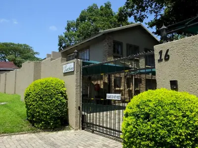 a house with a gate in front of it at Sunshine Self Catering in Nelspruit
