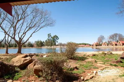 a view of a lake with trees and houses at Critchley Hackle in Dullstroom