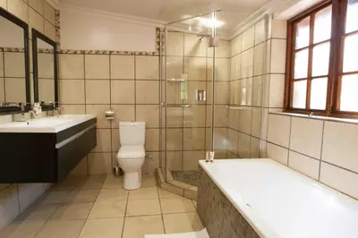 a bathroom with a tub and a toilet and a sink at Critchley Hackle in Dullstroom