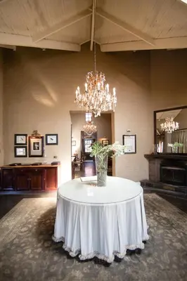 a large room with a table with a vase on it at Critchley Hackle in Dullstroom
