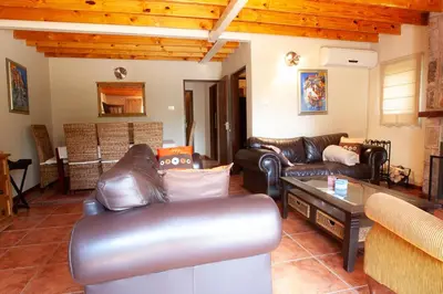 a living room with leather couches and a table at Critchley Common in Dullstroom