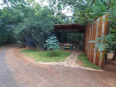 a building with a table inside of it next to a road at Vulture's View 5 in Hartbeespoort
