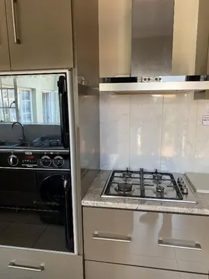 a kitchen with a stove and a counter top at The Valley, tranquil 3 bedroom home with pool in Midrand