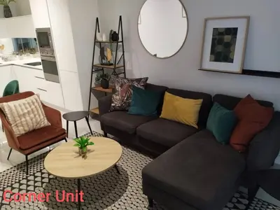 a living room with a couch and a table at Waterfall Luxury Apartment in Midrand