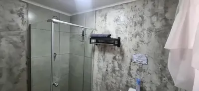 a bathroom with a shower with a glass shower stall at 7-on-Burger in Polokwane
