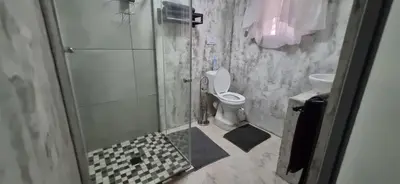 a bathroom with a shower with a toilet and a sink at 7-on-Burger in Polokwane