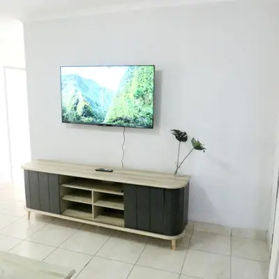 a living room with a tv on a wall at 43 Home self Catering with backup power and High speed WiFi in Witbank