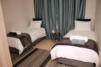 two beds in a small room with at 43 Home self Catering with backup power and High speed WiFi in Witbank