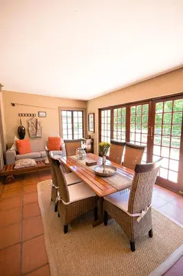 a dining room with a table and chairs at Downstream in Dullstroom