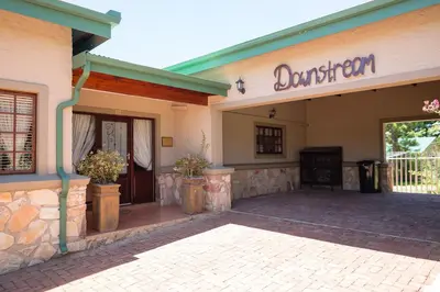 a entrance to a building with a sign on it at Downstream in Dullstroom