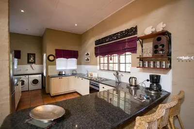 a kitchen with a counter top and a stove top oven at Downstream in Dullstroom