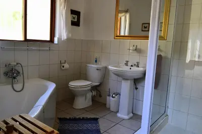a bathroom with a sink and a toilet and a bath tub at Upstream in Dullstroom