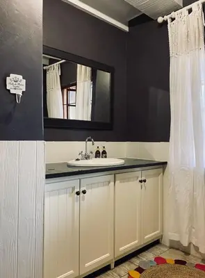a bathroom with a sink and a mirror at Fairstreams 4 in Dullstroom