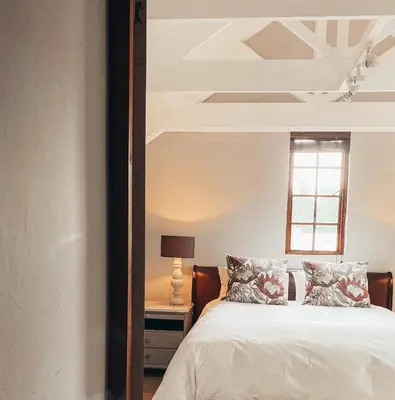 a bedroom with a bed and a mirror at Fairstreams 4 in Dullstroom