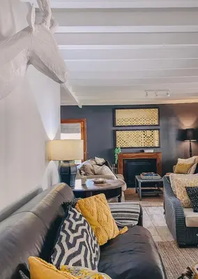 a living room with a couch and a fireplace at Fairstreams 4 in Dullstroom