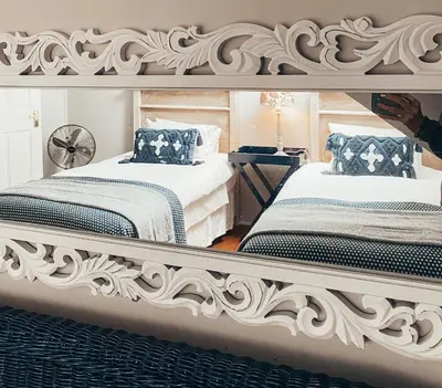 a bedroom with two beds and a large mirror at Fairstreams 4 in Dullstroom