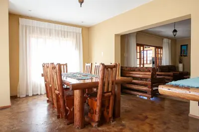a dining room with a table and chairs and a couch at Gecko Castle in Dullstroom