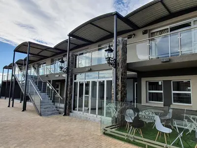 a building with stairs and chairs in front of it at SEA WATER BOUTIQUE LODGE in Mankweng unit G in Polokwane