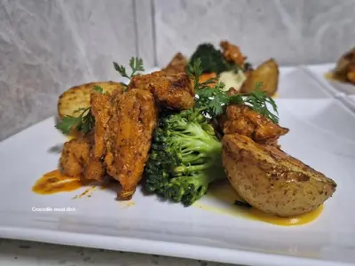 a plate of food with broccoli potatoes and meat at SEA WATER BOUTIQUE LODGE in Mankweng unit G in Polokwane