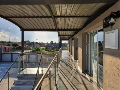 a balcony with awning and stairs on a building at SEA WATER BOUTIQUE LODGE in Mankweng unit G in Polokwane