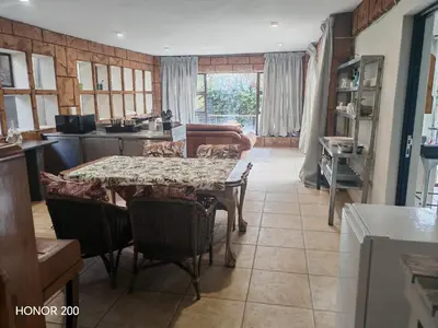 a kitchen with a table and chairs in a kitchen at House Olive in Pretoria