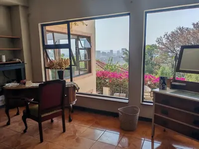 a room with a desk and a window with a view at House Olive in Pretoria