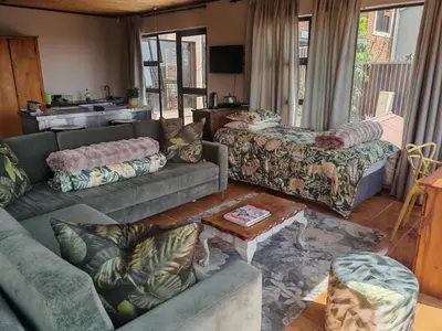 a living room with couches and a table at House Olive in Pretoria