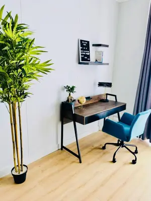 an office with a desk and a chair and a plant at Waterfall Views From The Six- Luxurious Apartment in Midrand