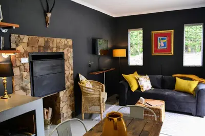 a living room with a couch and a fireplace at Salt on Dullstroom in Dullstroom