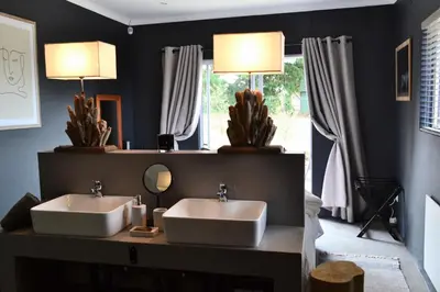 a bathroom with two sinks and two lamps and a mirror at Salt on Dullstroom in Dullstroom