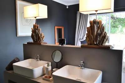 a bathroom with two sinks and a mirror at Salt on Dullstroom in Dullstroom