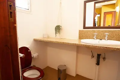a bathroom with a toilet and a sink and a mirror at Sanctuary in Dullstroom