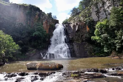 a waterfall in the middle of a river at Waterval in Dullstroom