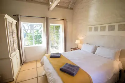 a bedroom with a large bed with two towels on it at Waterval in Dullstroom
