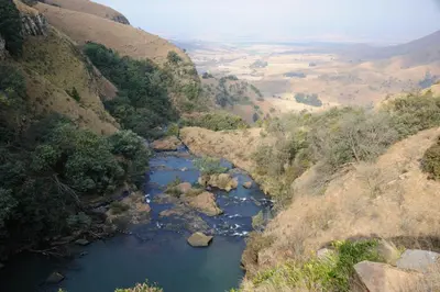 a view of a river in a valley at Waterval in Dullstroom