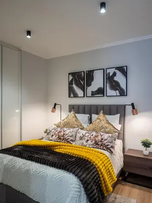 a bedroom with a bed with a yellow blanket on it at eKhaya at Ellipse Waterfall City in Midrand