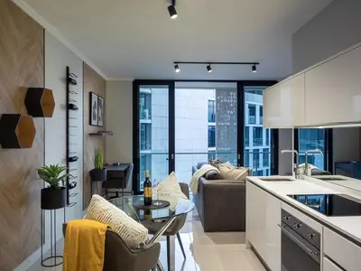 a kitchen and living room with a couch and a table at eKhaya at Ellipse Waterfall City in Midrand
