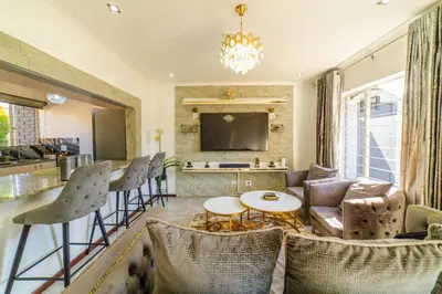 a living room with a couch and a table and chairs at Homes of Ace 3 bedroom Villa in Pretoria