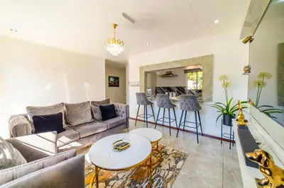 a living room with a couch and a table at Homes of Ace 3 bedroom Villa in Pretoria