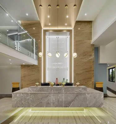a lobby with a large marble table in the middle at Luxury 2BR Loft with Patio Near Menlyn at the Regency in Pretoria